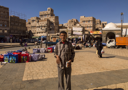 Yemeni man in front of traditional mudbrick houses, Amanat Al-Asemah, Sanaa, Yemen