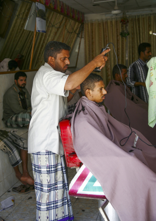 Hairdresser cutting man hair, Hadhramaut, Tarim, Yemen