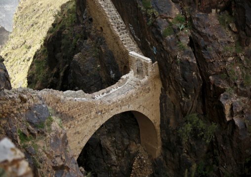 The Shahara bridge over a rocky gorge, Amran Governorate, Shaharah, Yemen