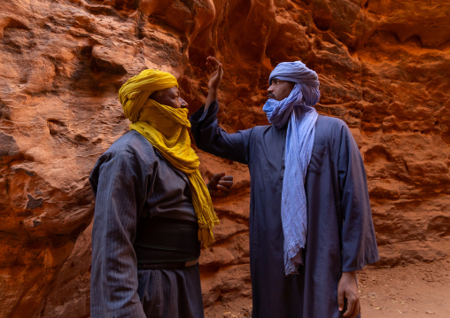 Tuaregs inside a sandstone path, Tassili N'Ajjer National Park, Tadrart Rouge, Algeria