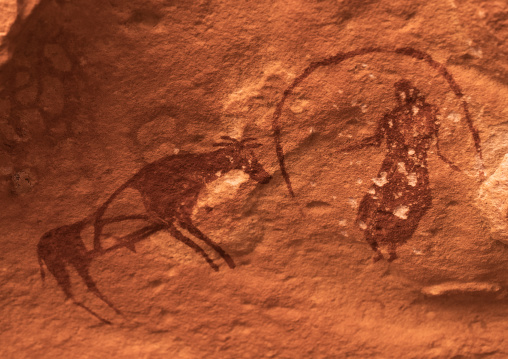 Rock painting depicting a woman with a cow, Tassili N'Ajjer National Park, Tadrart Rouge, Algeria