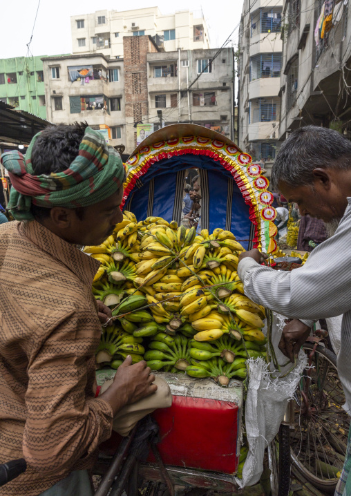 Bangladeshi men loading bananas at Kawran Bazar morning market, Dhaka Division, Dhaka, Bangladesh