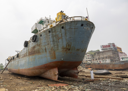 Bangladeshi man standing near a ship at Dhaka Shipyard, Dhaka Division, Keraniganj, Bangladesh
