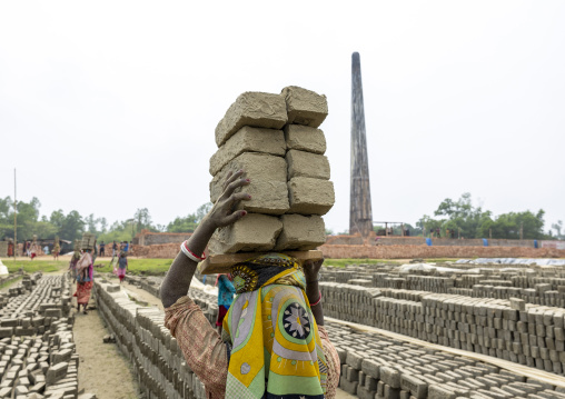 Women carrying bricks on their heads at a brick factory, Sylhet Division, Bahubal, Bangladesh