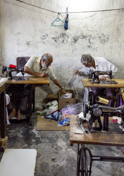 Bangladeshi men working on sewing machines in a workshop, Rajshahi Division, Rajshahi, Bangladesh