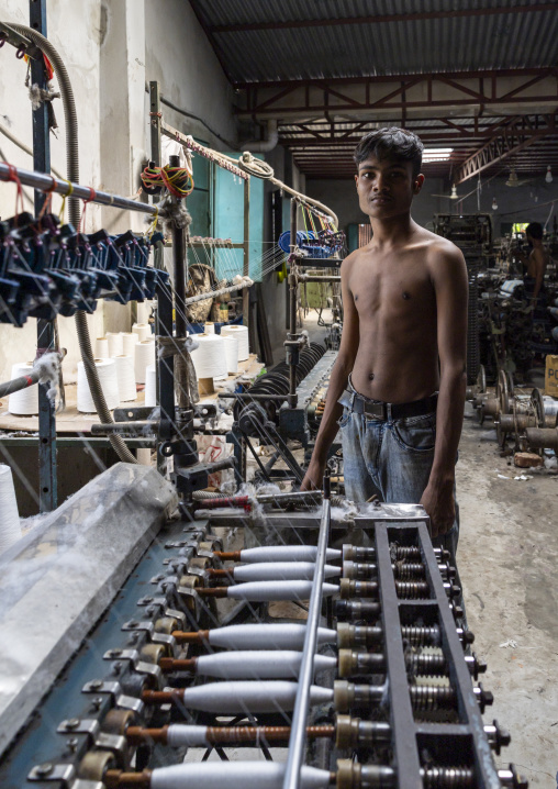 Bangladeshi man working in a extile factory looms, Dhaka Division, Rupganj, Bangladesh