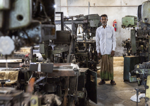 Bangladeshi man working in a extile factory looms, Dhaka Division, Rupganj, Bangladesh