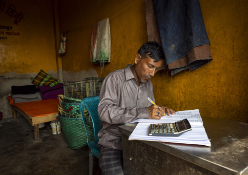 Portrait of a bangladeshi man working in an office at a fish market, Chittagong Division, Chittagong, Bangladesh