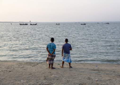 Bangladeshi men looking the sea and fishing boats, Chittagong Division, Cox's Bazar Sadar, Bangladesh