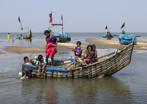 Bangladeshi children playing near moon fishing boats, Chittagong Division, Cox's Bazar Sadar, Bangladesh