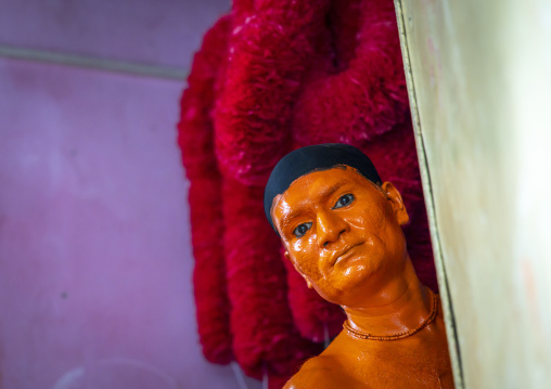 Portrait of a Hindu devotee covered with orange color in Lal Kach festival, Dhaka Division, Munshiganj Sadar, Bangladesh