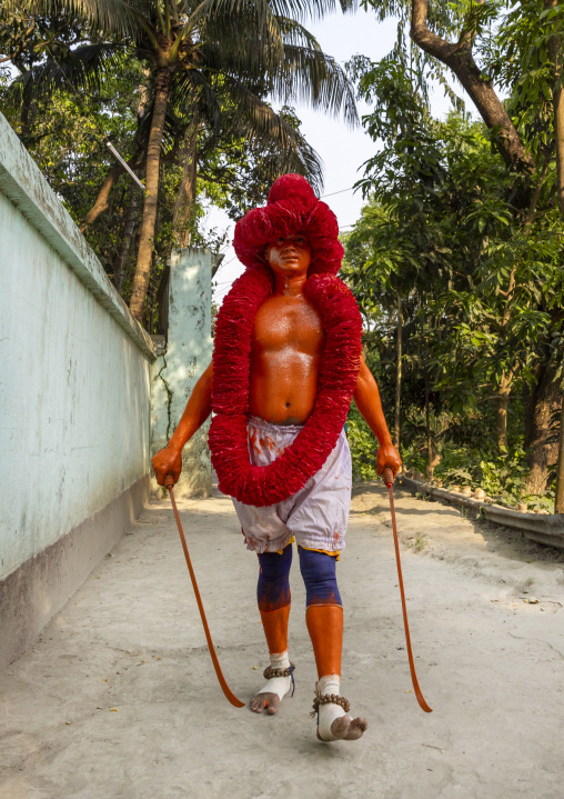 Portrait of a Hindu devotee covered with orange color in Lal Kach festival, Dhaka Division, Munshiganj Sadar, Bangladesh