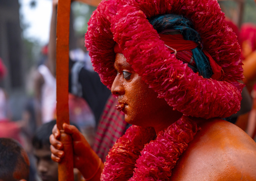 Hindu devotee with a sword covered with orange color at Lal Kach festival, Dhaka Division, Munshiganj Sadar, Bangladesh