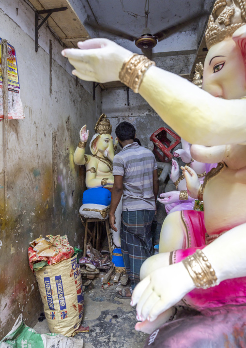 Bangladeshi artist painting a statue of Ganesha, Dhaka Division, Dhaka, Bangladesh