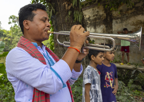 Bangladeshi musician playing trumpet during Lal Kash festival, Dhaka Division, Munshiganj, Bangladesh