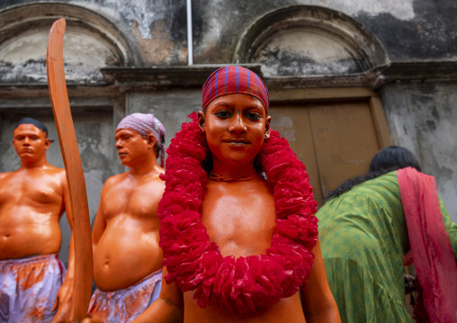 Young hindu devotee covered with orange color at Lal Kach festival, Dhaka Division, Munshiganj, Bangladesh