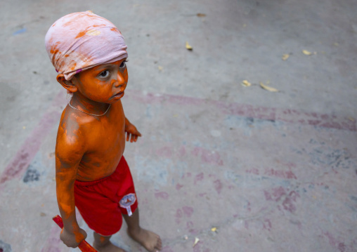 Young hindu devotee covered with orange color at Lal Kach festival, Dhaka Division, Munshiganj, Bangladesh