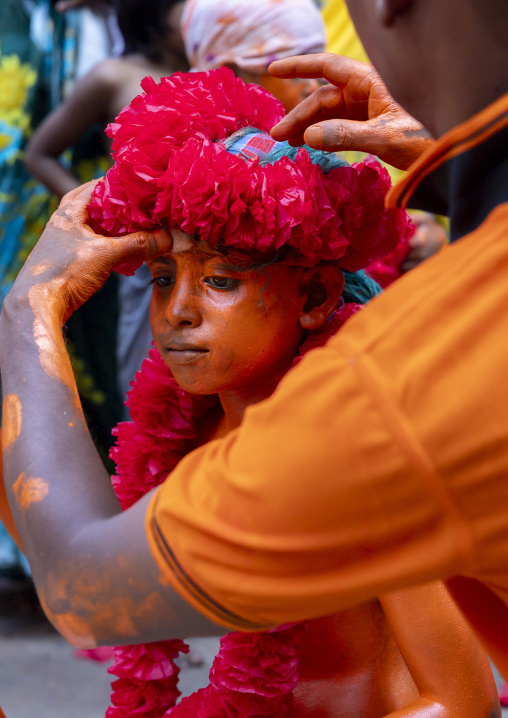 Dressing of a young Hindu devotee in orange color at Lal Kach festival, Dhaka Division, Munshiganj, Bangladesh