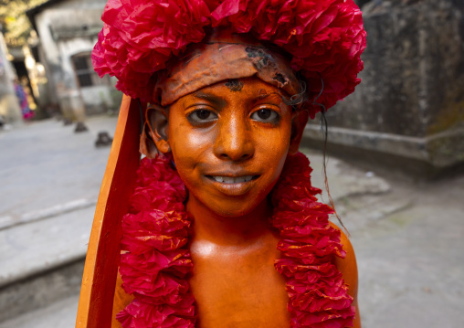 Young hindu devotee covered with orange color at Lal Kach festival, Dhaka Division, Munshiganj, Bangladesh