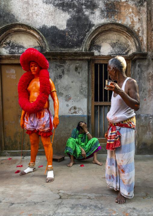 Hindu devotee covered with orange color at Lal Kach festival, Dhaka Division, Munshiganj, Bangladesh