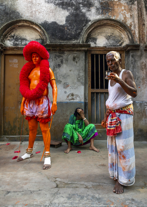 Hindu devotee covered with orange color at Lal Kach festival, Dhaka Division, Munshiganj, Bangladesh