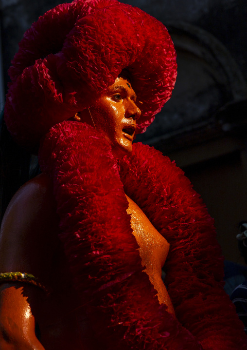 Portrait of a Hindu devotee covered with orange color at Lal Kach festival, Dhaka Division, Munshiganj, Bangladesh