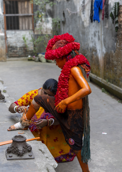 Young Hindu devotee covered with orange color dressing at Lal Kach festival, Dhaka Division, Munshiganj, Bangladesh