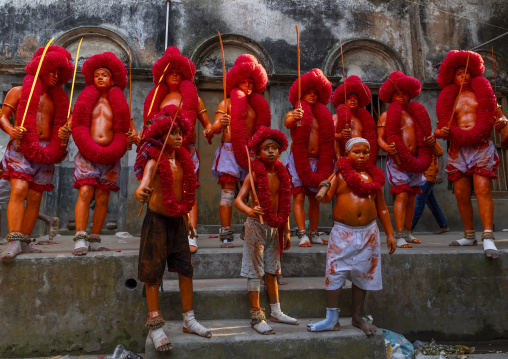 Hindu devotees with swords in orange color in line at Lal Kach festival, Dhaka Division, Munshiganj, Bangladesh