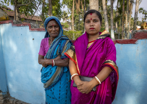 Portrait of two hindu women against a blue wall, Sylhet Division, Kamalganj, Bangladesh