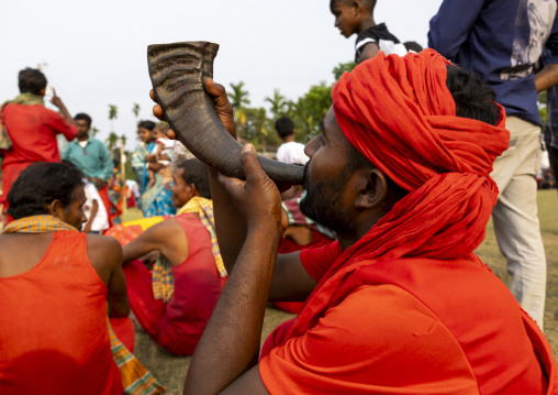 Devotee blowing in a horn during Charak Puja hindu festival, Sylhet Division, Kamalganj, Bangladesh