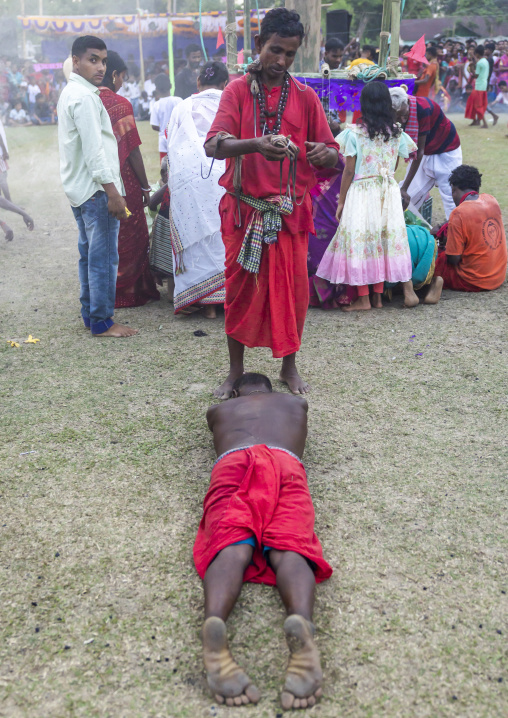 Devotee waiting to receive a hook for a body suspension in Charak Puja, Sylhet Division, Kamalganj, Bangladesh
