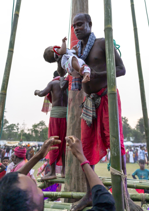 Devotee blessing a baby after body suspension during Charak Puja, Sylhet Division, Kamalganj, Bangladesh