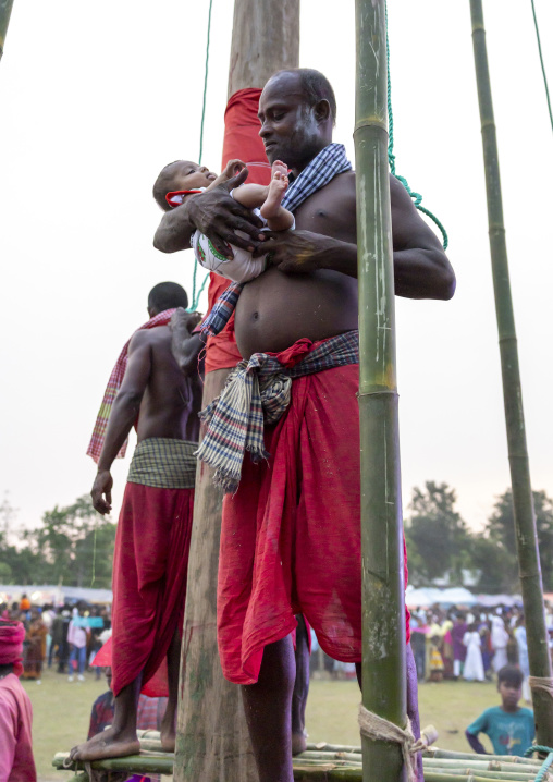 Devotee blessing a baby after body suspension during Charak Puja, Sylhet Division, Kamalganj, Bangladesh