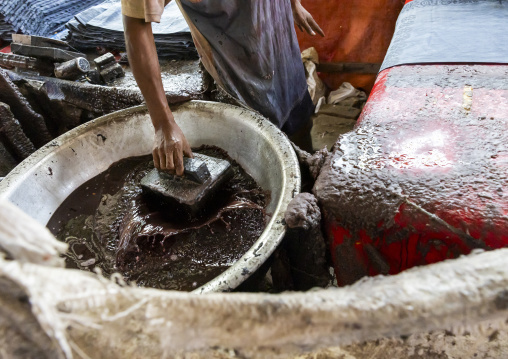 Bangladeshi man stamping wax on a cloth in a batik factory, Chittagong Division, Comilla, Bangladesh