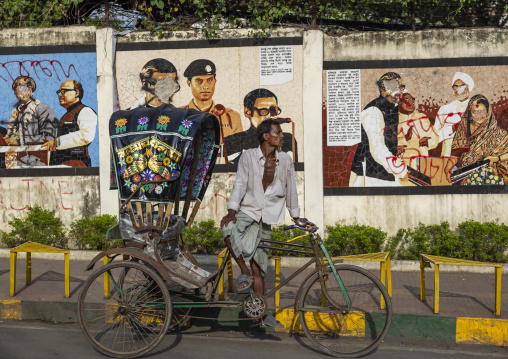 Rickshaw parked in front of political murals in the town, Chittagong Division, Chittagong, Bangladesh