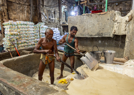 Bangladeshi men washing salt in water in a factory, Chittagong Division, Chittagong, Bangladesh