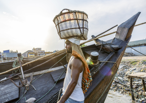 Bangladeshi man weighing basket with salt at a factory, Chittagong Division, Chittagong, Bangladesh