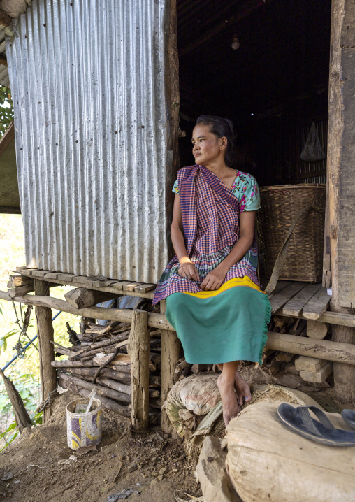 Tanchangya ethnic group woman sit in the door of her house, Chittagong Division, Bandarban, Bangladesh