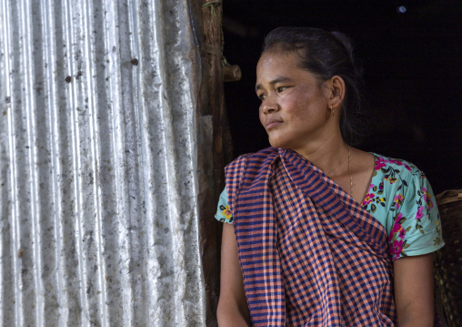 Tanchangya ethnic group woman sit in the door of her house, Chittagong Division, Bandarban, Bangladesh