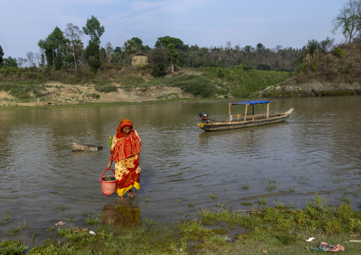 Bangladeshi woman walking in the river, Chittagong Division, Rowangchhari, Bangladesh