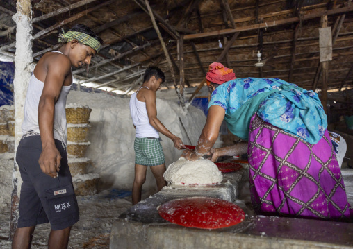Bangladeshi workers washing salt in water in a factory, Chittagong Division, Chittagong, Bangladesh