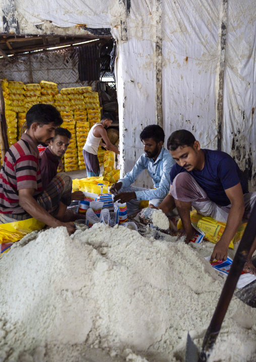 Bangladeshi men packing salt in plastic bags, Chittagong Division, Chittagong, Bangladesh