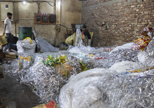 Bangladeshi men dismantling plastic bags for recycling, Dhaka Division, Dhaka, Bangladesh