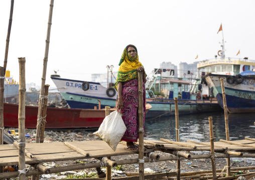 Portrait of a bangladeshi old woman carrying a bag in the port, Dhaka Division, Keraniganj, Bangladesh