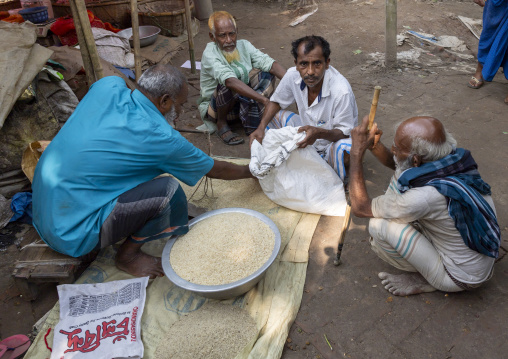 Bangladeshi man buying rice in a market, Dhaka Division, Dhamrai, Bangladesh
