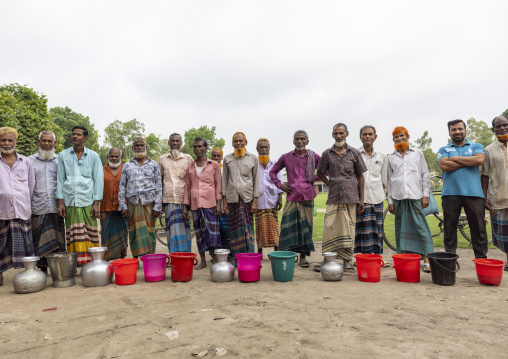 Bangladeshi farmers selling their fresh cow milk in the market, Dhaka Division, Dhamrai, Bangladesh