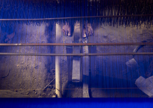 Feet of a man weaving in a sari factory, Dhaka Division, Delduar, Bangladesh