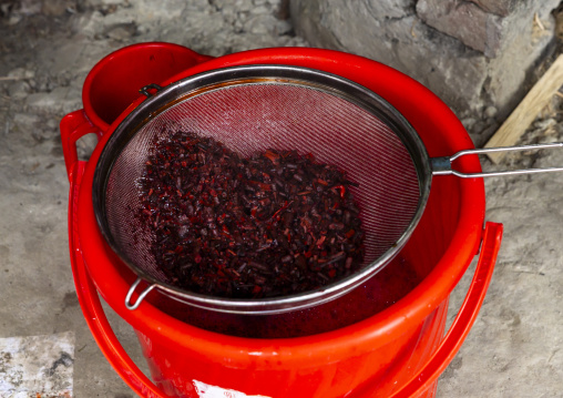 Bangladeshi man dyeing fabrics in red in Living Blue company, Rangpur Division, Goalpara, Bangladesh