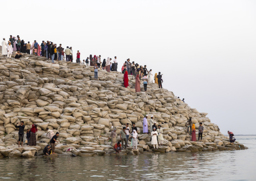 People walking on bags filled with sand to prevent from erosion, Rajshahi Division, Rajshahi, Bangladesh