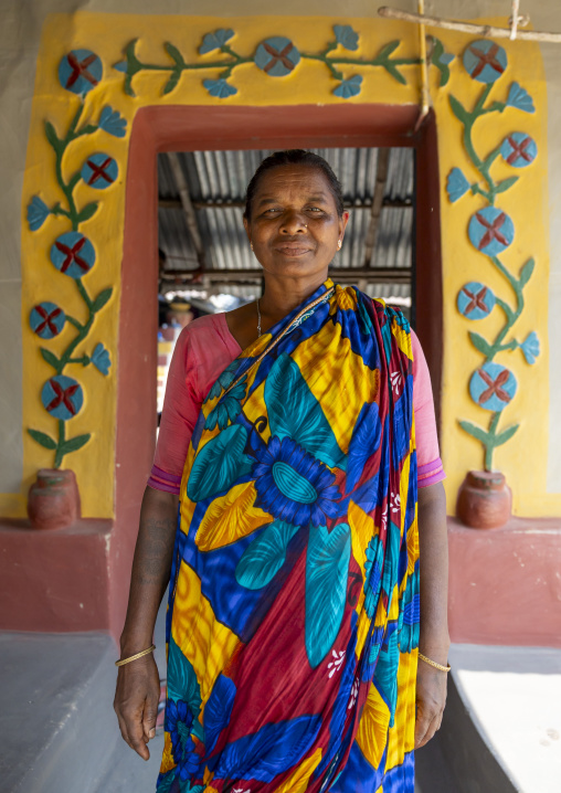 Christian woman from Santal ethnic group in front of a decorated door, Rajshahi Division, Tanore, Bangladesh